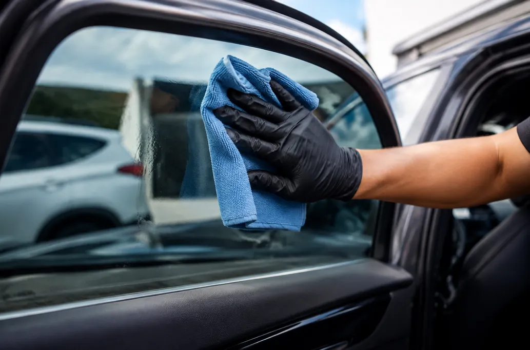 Microfiber cleaning of vehicle glass — illustrative detailing image